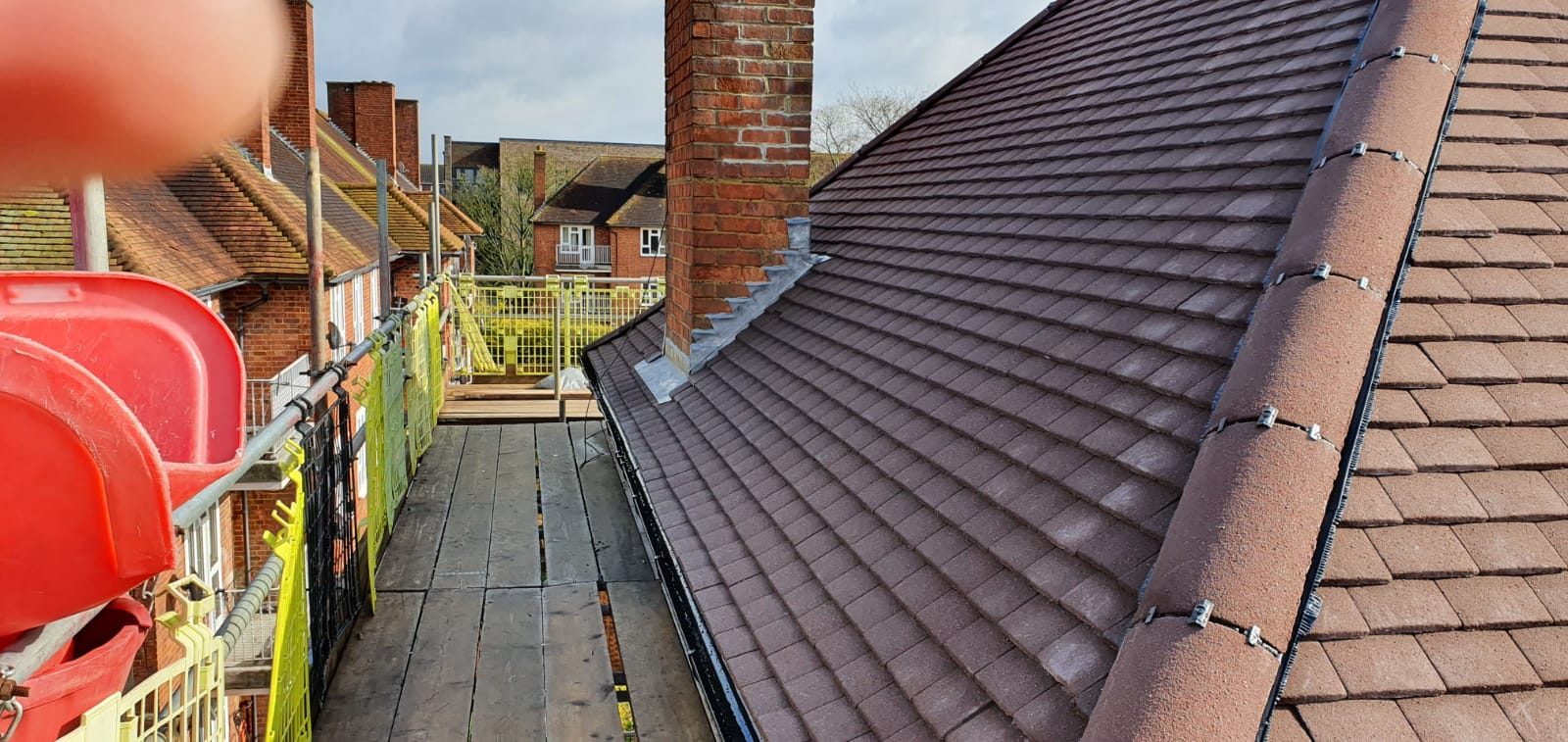 Completed - The completed tiled roof showing the new roof covering, ridge tiles and lead flashing around the chimney