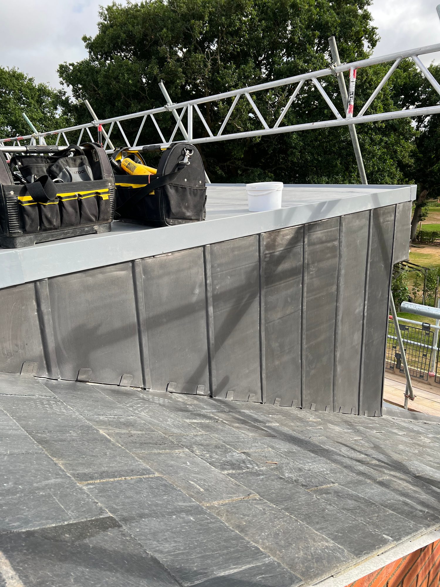 Completed - Completed roof showing the lead-clad upstand and finished slate covering