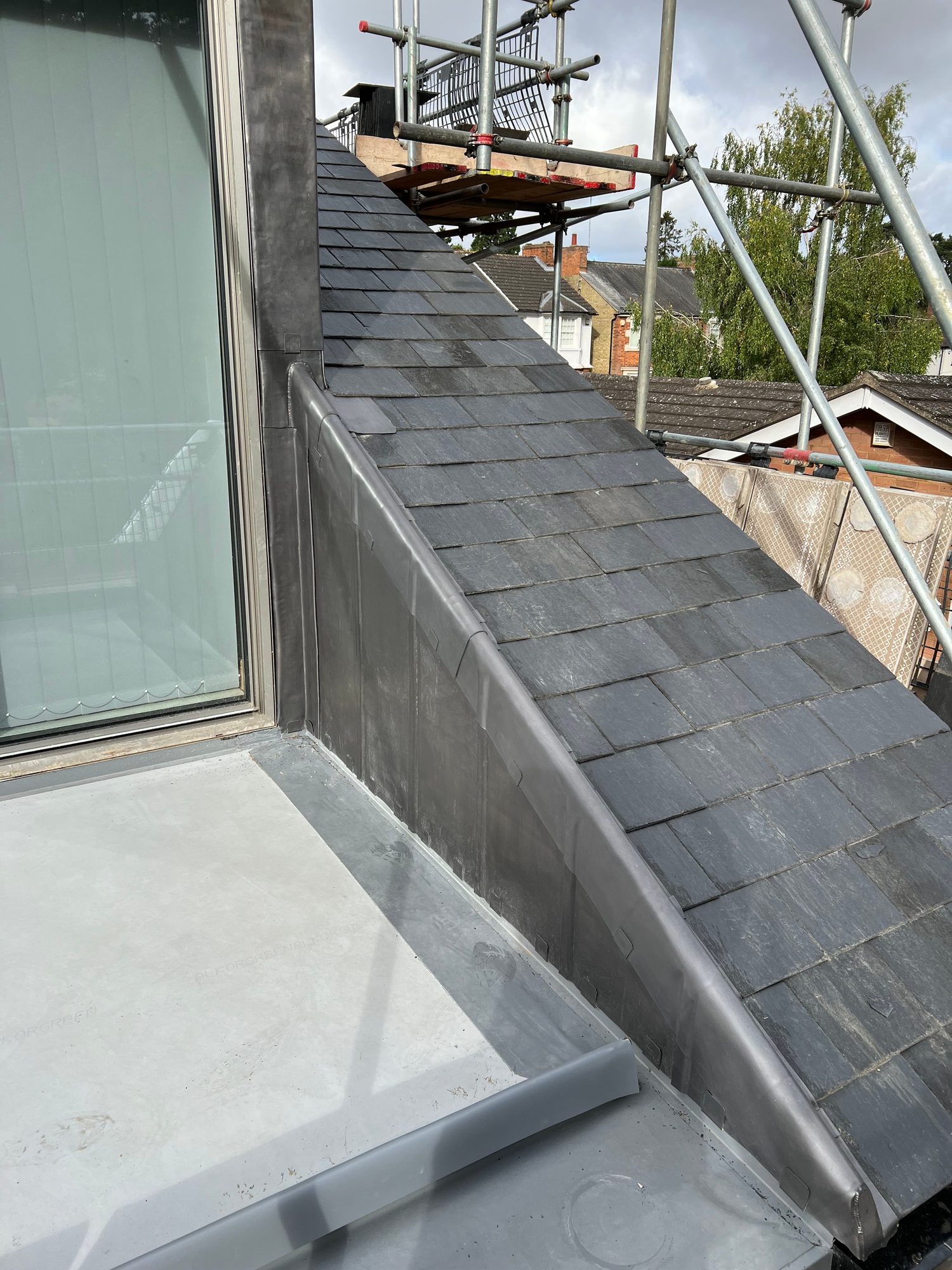 Completed - Completed slate roof showing the finished leadwork and roof detailing
