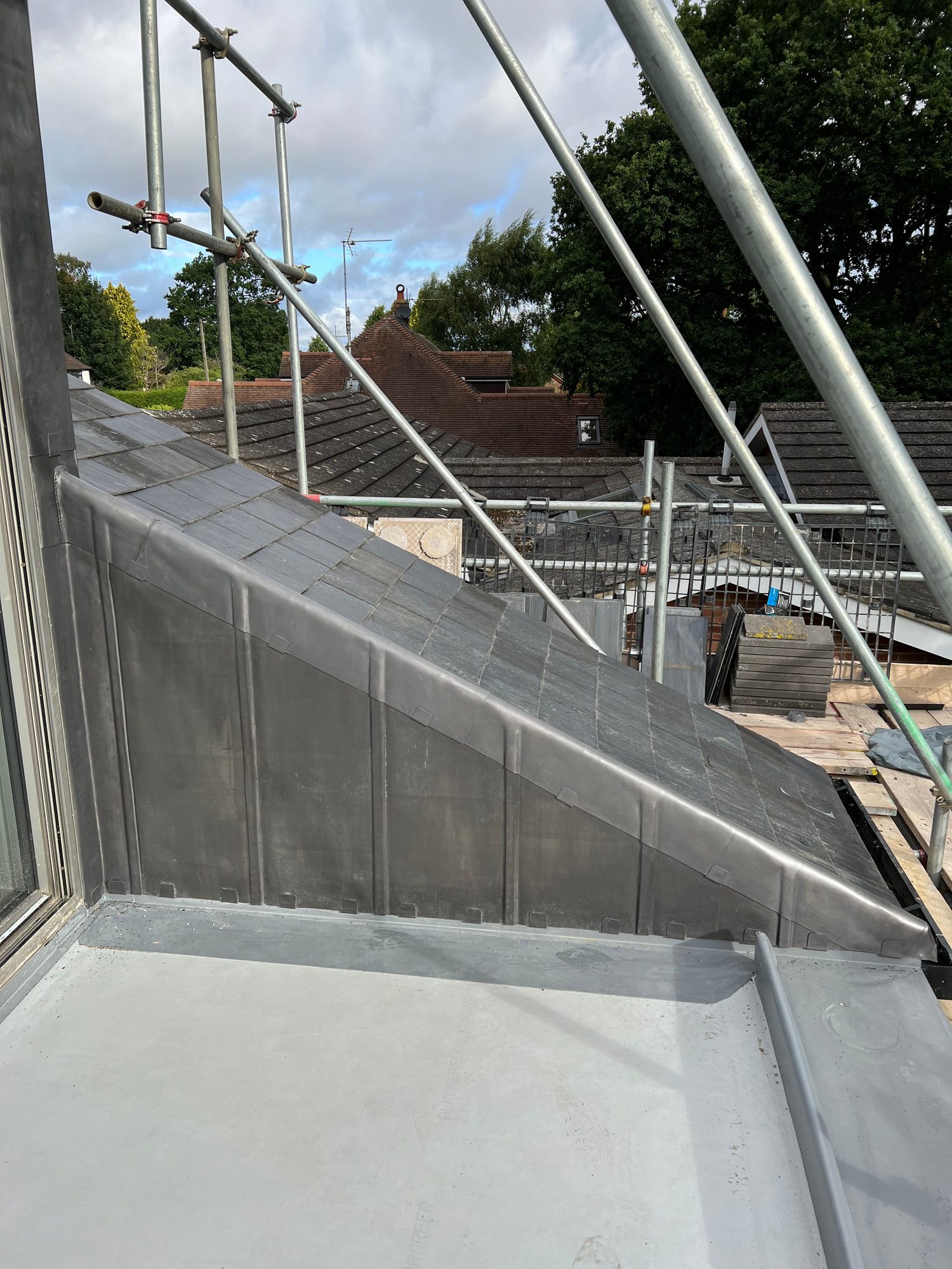 Completed - Completed slate roof showing the finished leadwork and surrounding roof detailing