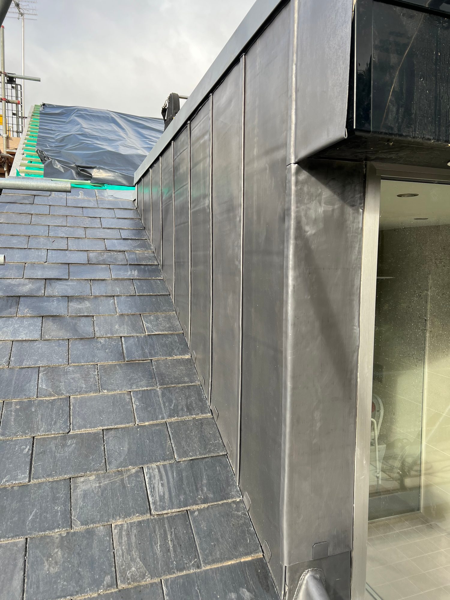 Completed - Completed slate roof with finished lead cladding around the dormer structure