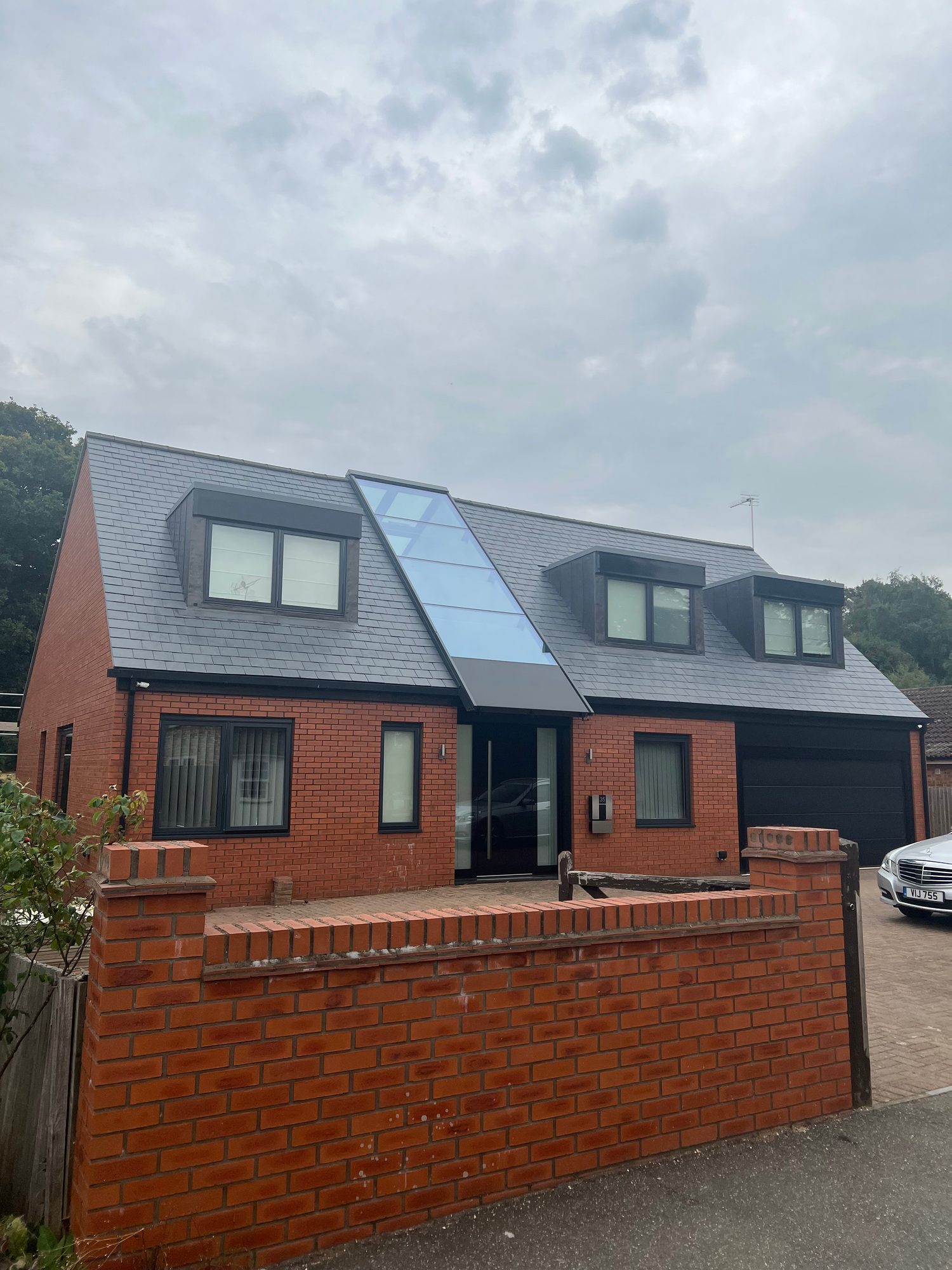 Completed - The completed slate roof with three dormer windows and the central glazed roof feature
