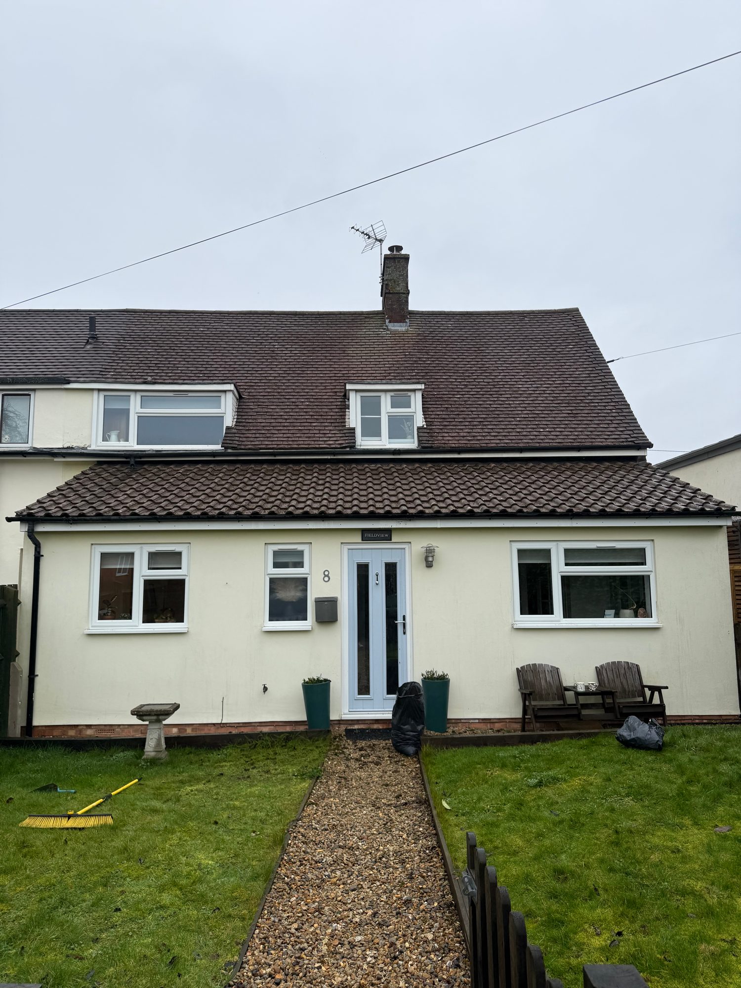 Main roof and lower extension cleared of moss with the original tiles fully visible
