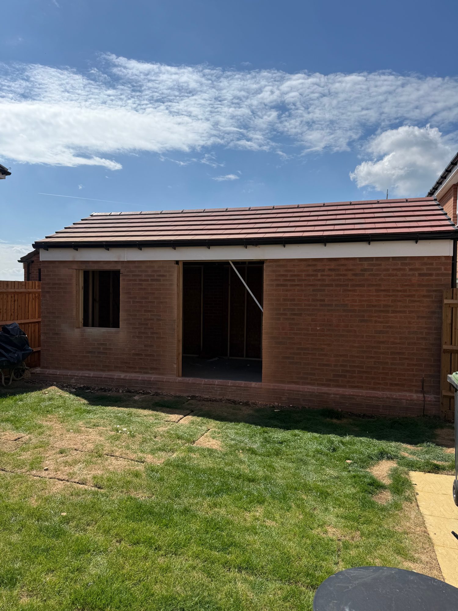 Garage exterior with unfinished window and doorway openings ready for frames and glazing